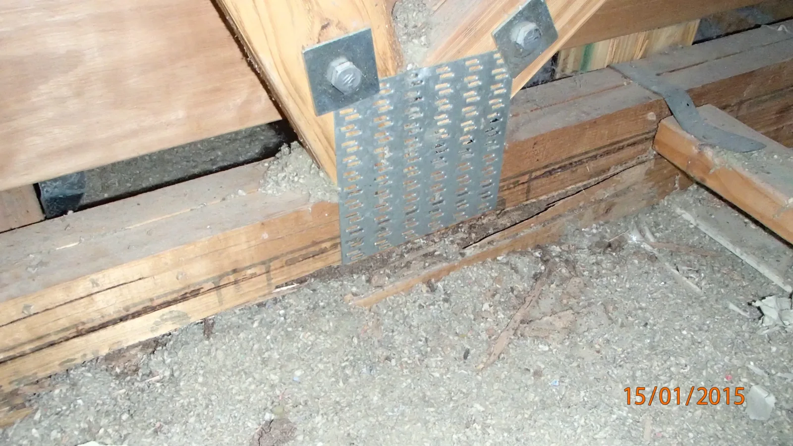 Visible deterioration to a lower timber member beside a metal connector plate